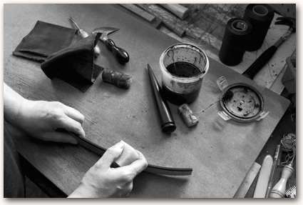 Burnishing the leather edges with beeswax